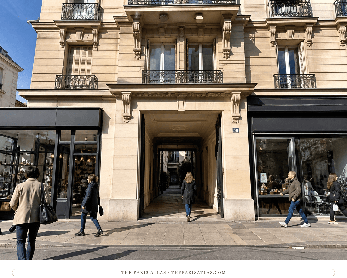 Bright present-day view of the pale stone façade and deep passage at 38 boulevard Raspail