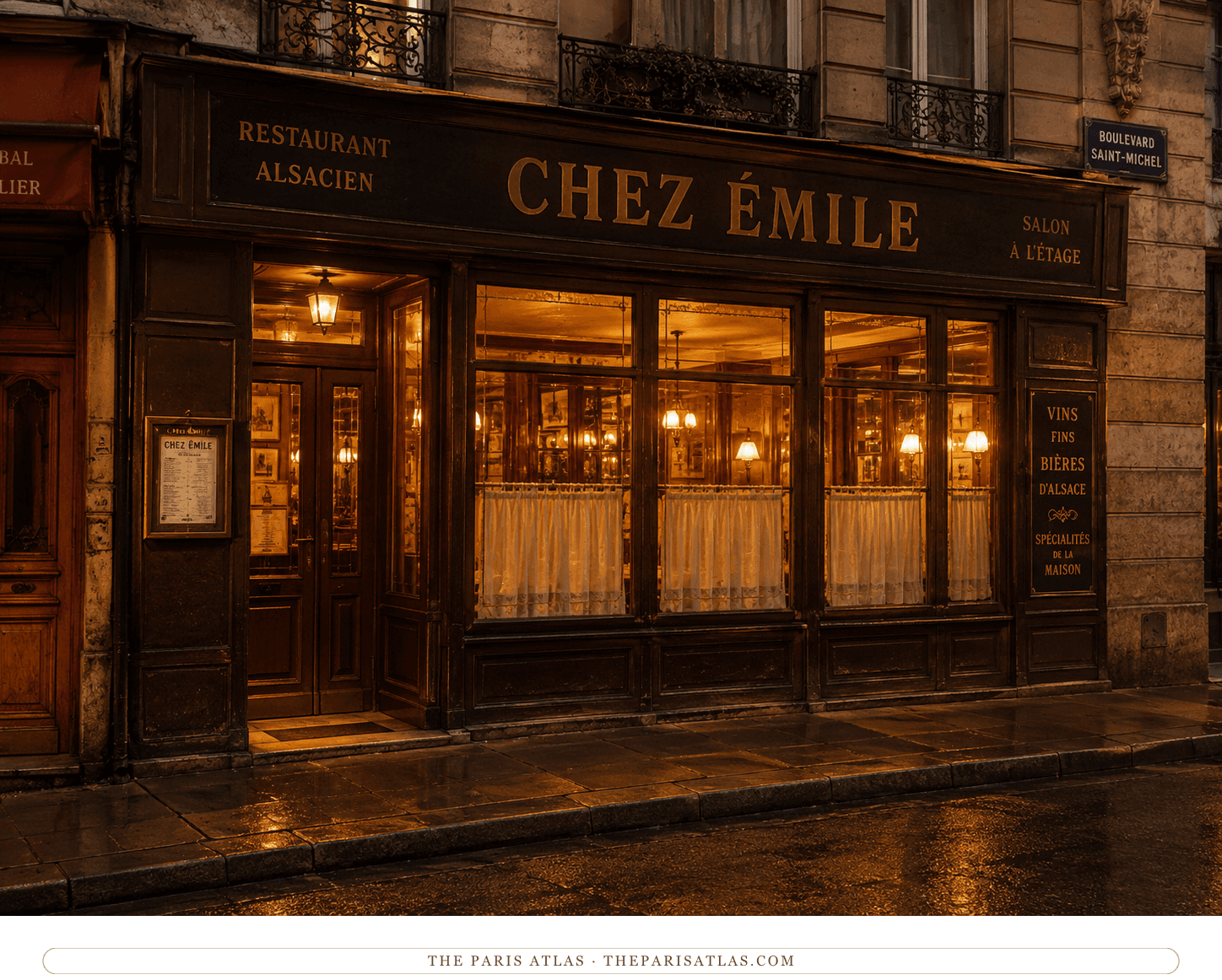 Chez Émile glowing at night, warm light through the lace curtains onto the wet pavement of the boulevard