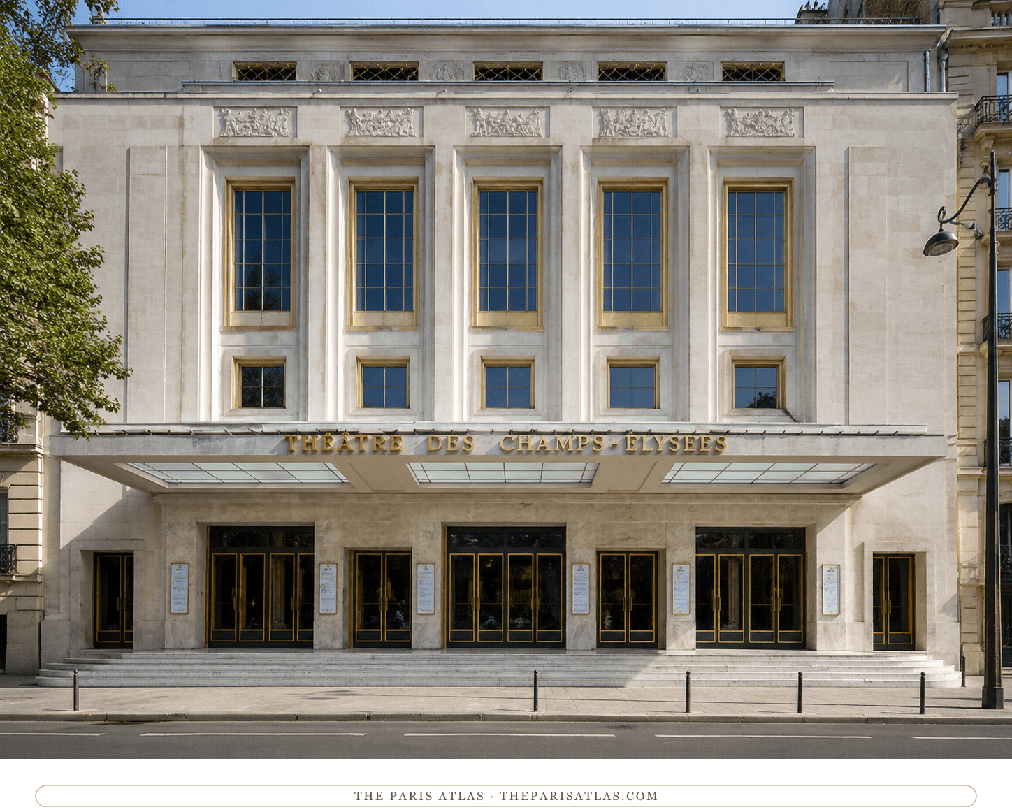 The theater's pale stone-and-concrete front in daylight, gilded reliefs above the marquee and trees along the avenue
