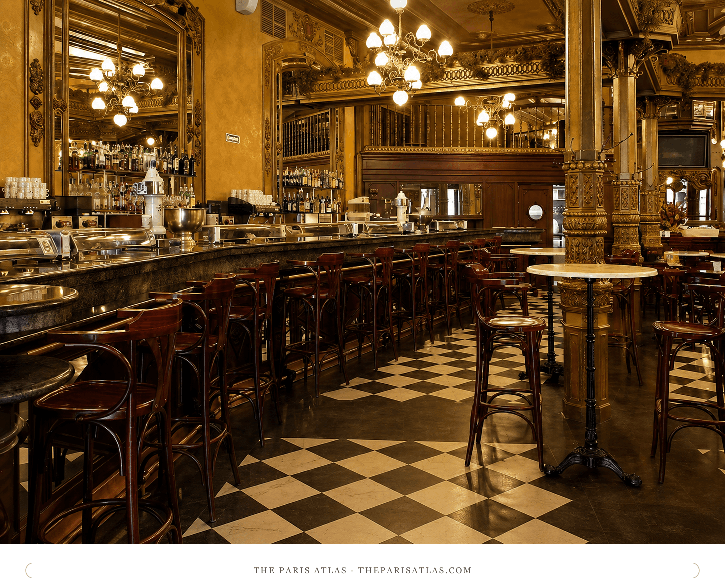 The Café Iruña's bar room in color, the gilt columns and mirrored walls warm under the chandeliers above the checkerboard marble floor