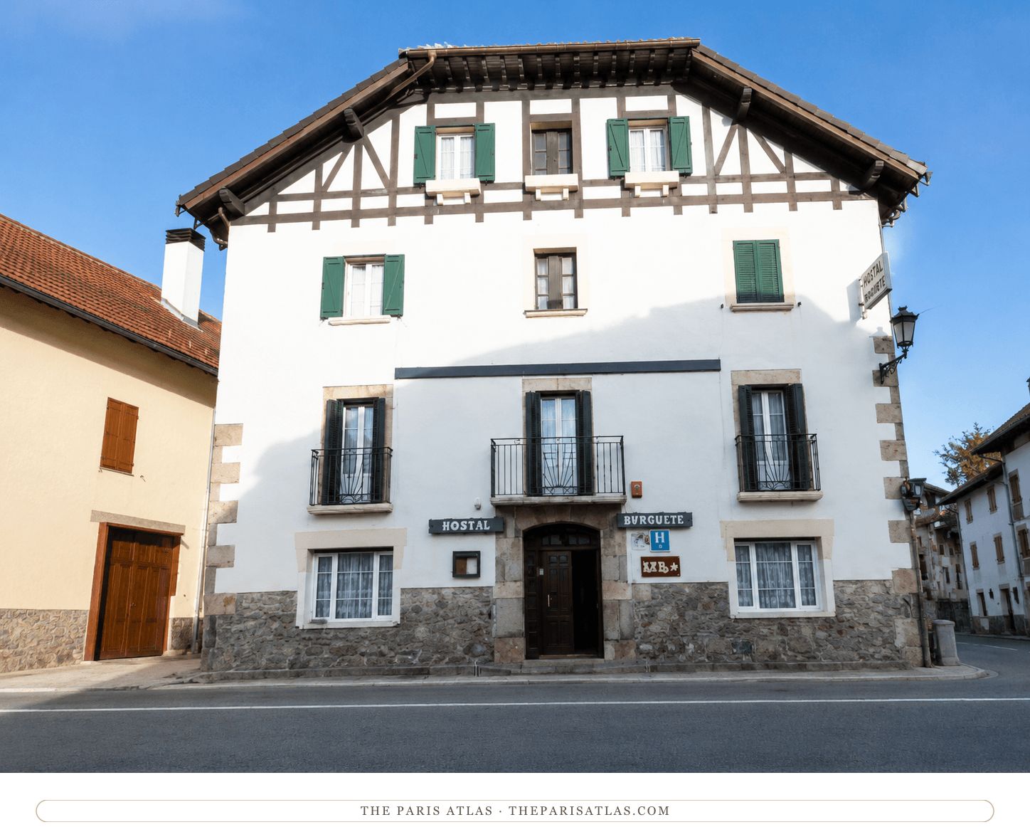 The half-timbered village inn at Auritz/Burguete in color, shutters open over the quiet street