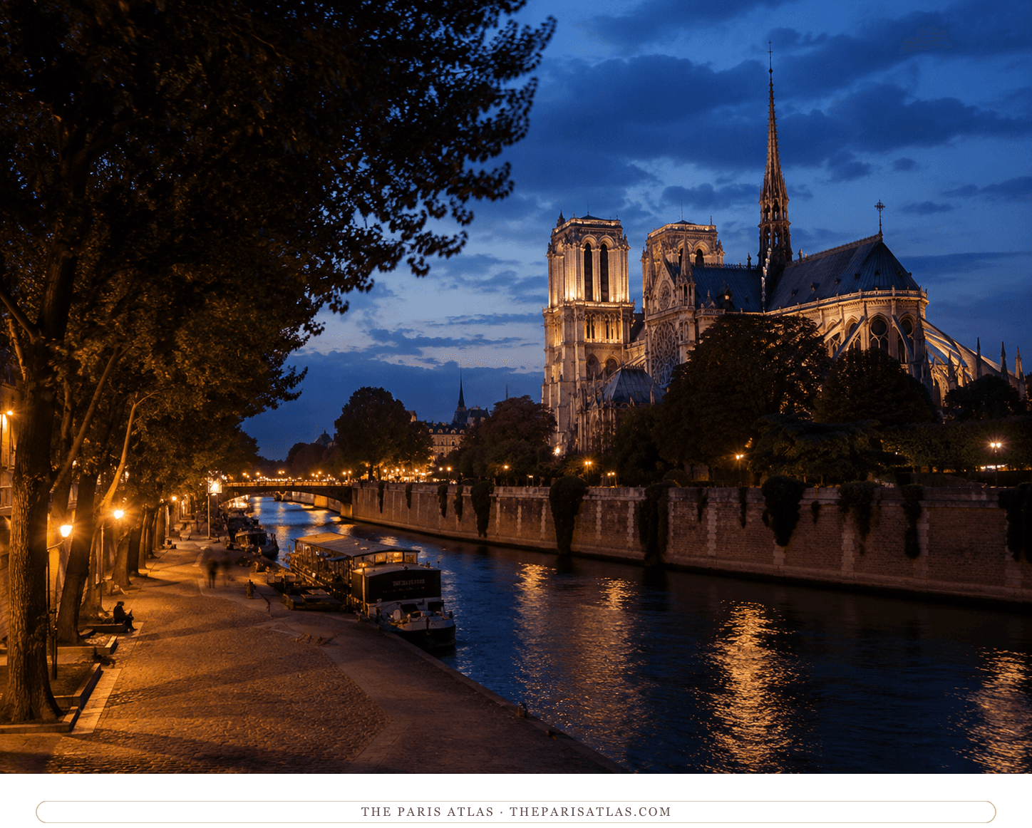 The Seine at dusk, lamps glowing along the tree-lined quai and Notre-Dame lit above the water downstream