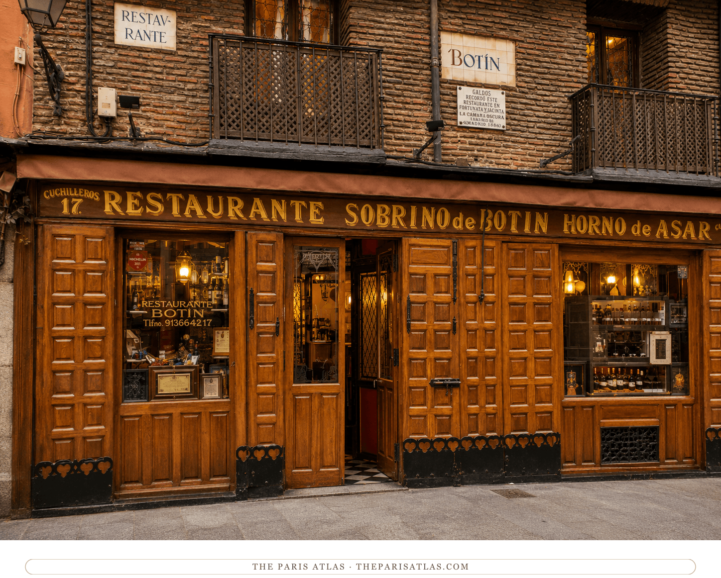 Restaurante Botín's wooden storefront glowing warm at dusk, wine in the windows and the tiled Botín sign above