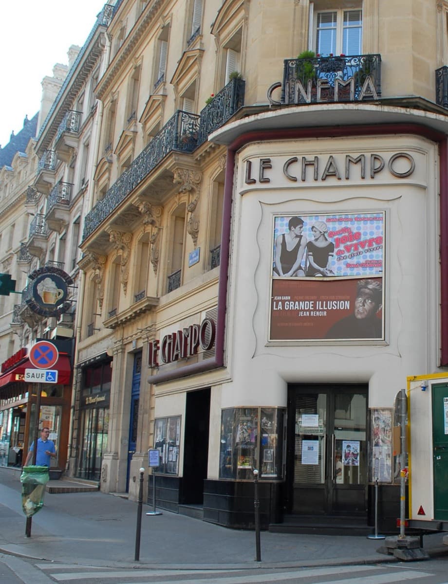 The corner façade of Le Champo cinema by day, a restored-print poster for Jean Renoir's La Grande Illusion on the marquee