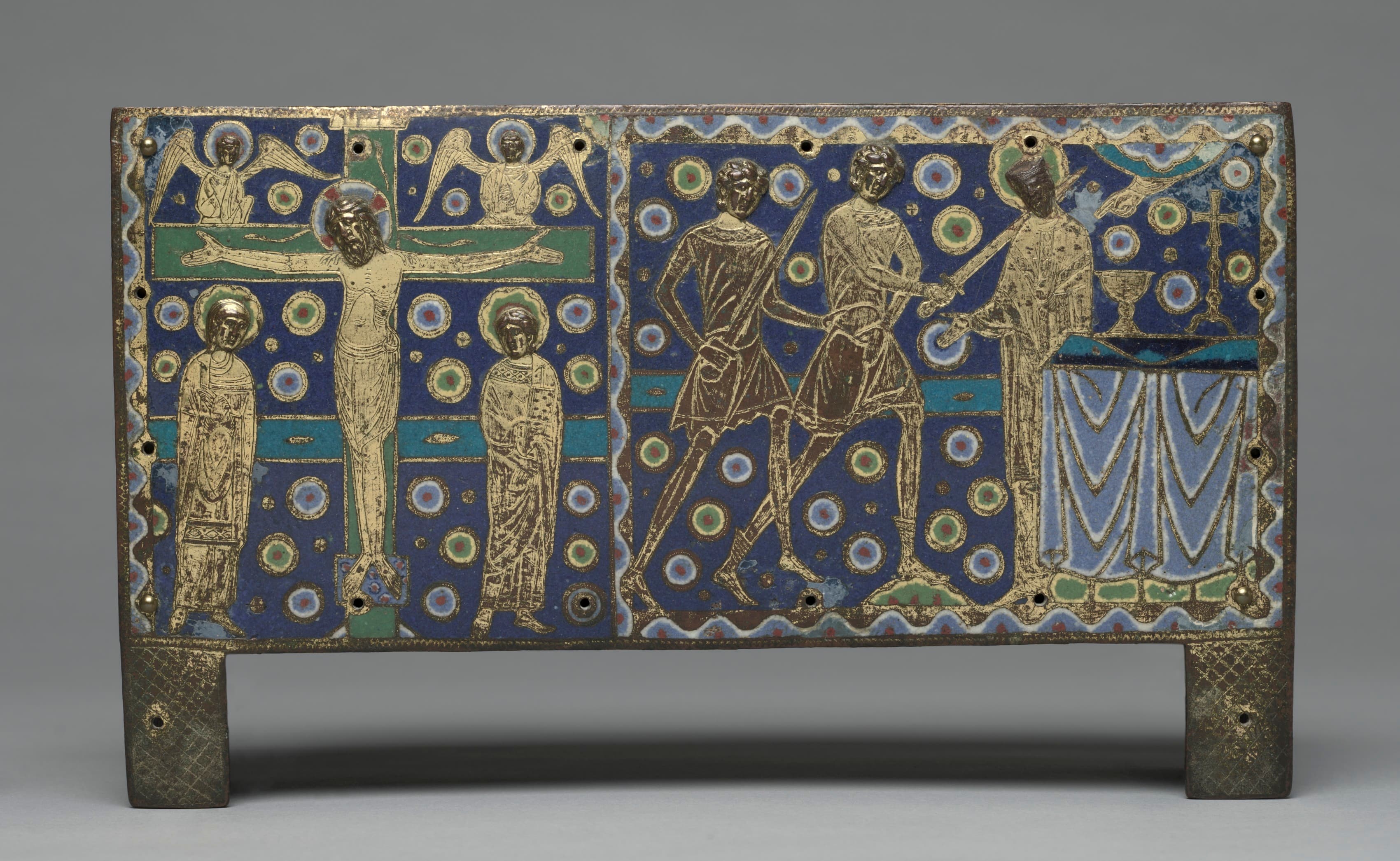 A rectangular enamel plaque on a deep blue ground scattered with small rosettes. On the left, Christ on the cross between two standing figures, with two angels above. On the right, three men in short tunics stride forward with drawn swords towards a robed figure standing at a draped altar with a chalice on it. The figures are gilded and engraved; the blue is champleve enamel.