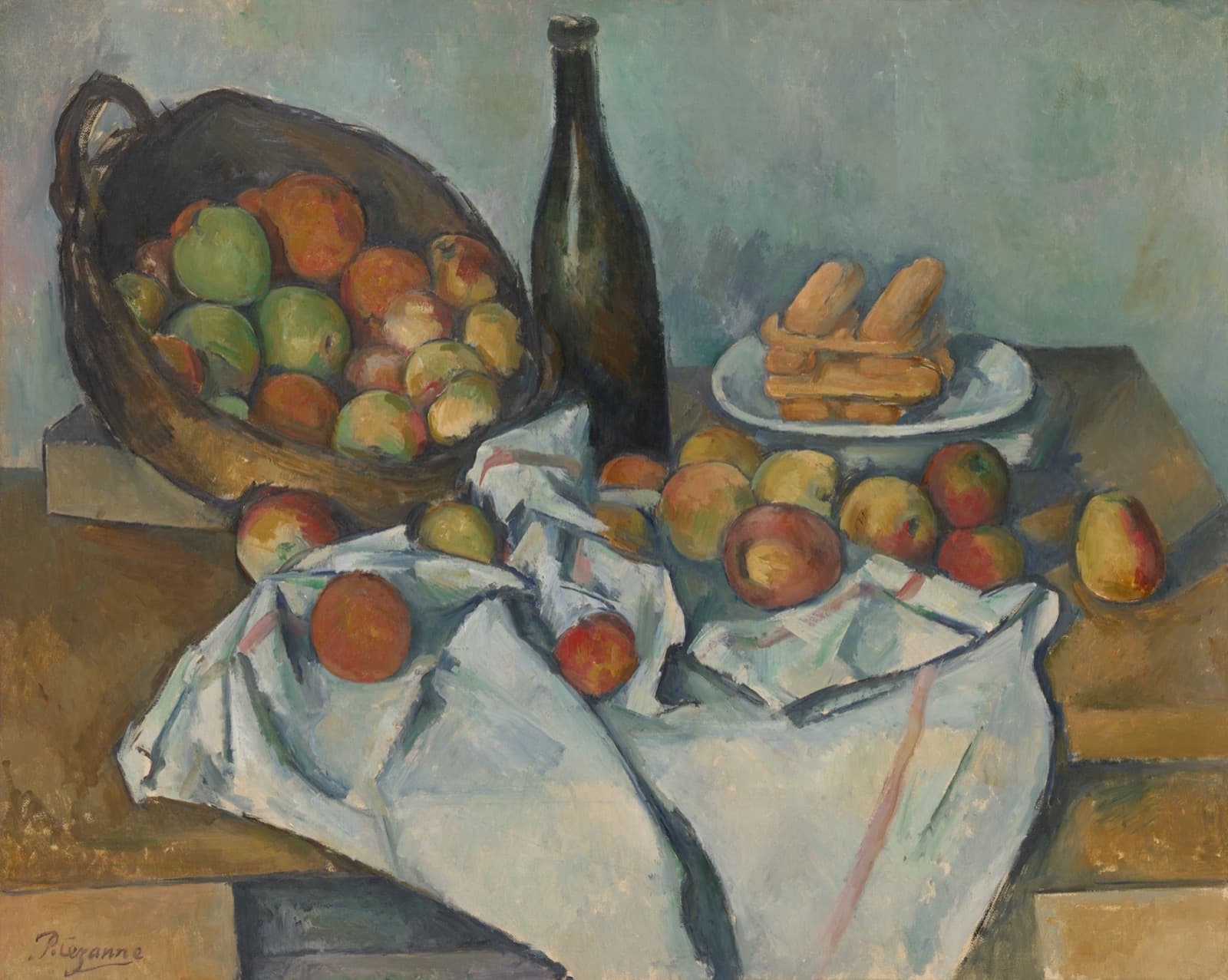 A still life on a table. A wicker basket tips up on a wooden block at the left, spilling red and green apples. A dark green wine bottle stands behind it, leaning slightly. At the right a white plate holds a stack of pale finger biscuits. A rumpled white cloth runs across the table with more apples on it, and the edge of the table on the left does not line up with the edge on the right.