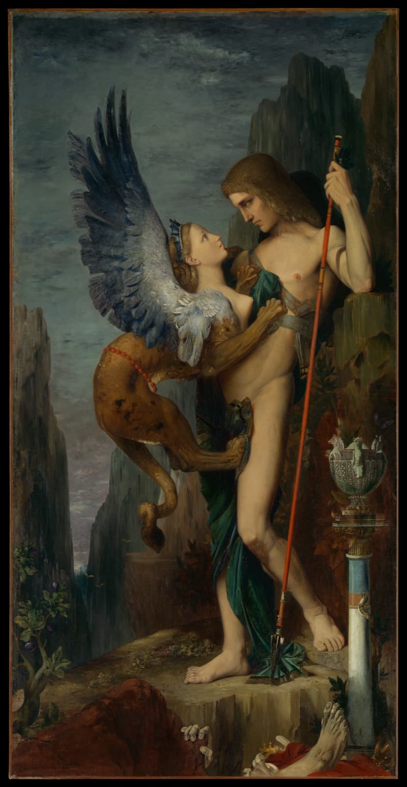 A nude young man stands on a rocky ledge holding a long red-shafted spear upright. A sphinx with a young woman's head and bare torso, a tawny lion's body and large blue-grey wings has sprung against his chest, its front paws hooked into him, staring up into his face while he looks steadily down at her. On the ledge below lie a pale human foot, scattered fingers, a red cloth and a gold crown; a narrow rocky gorge and grey sky fill the background, with an ornamented urn on a column at the right.