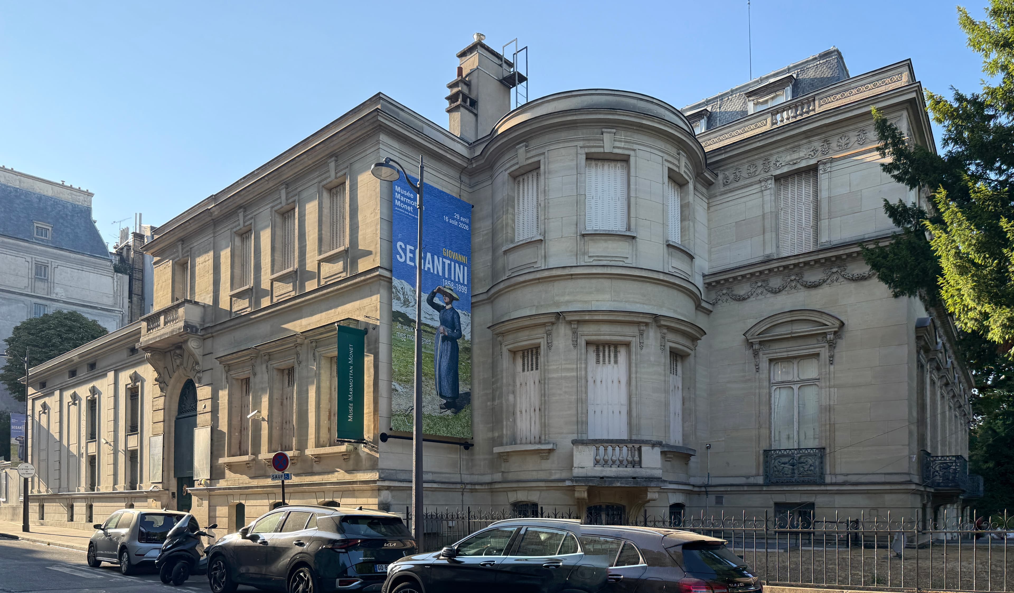 The Musée Marmottan Monet from the rue Louis-Boilly: a nineteenth-century townhouse behind railings and trees, with the museum's banner at the entrance