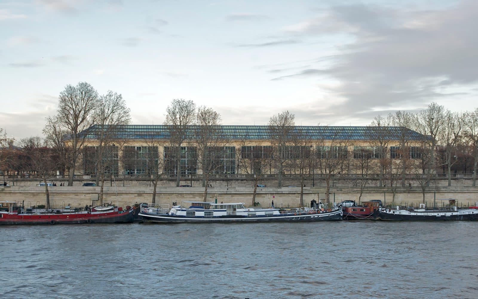 The Orangerie seen from across the Seine, its long glazed roof above the trees of the river terrace