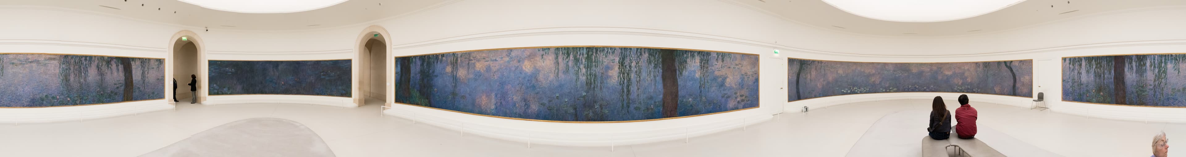 Full panorama of the second oval Water Lilies room: four curved compositions of willows and water under diffused light