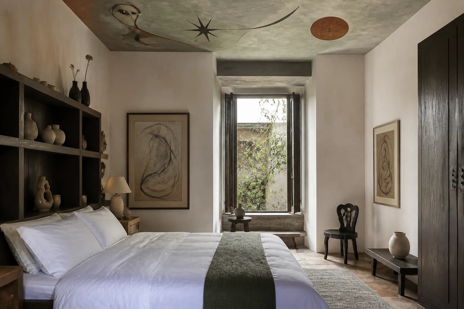 Editorial illustration of an artist-studio room at Hôtel des Académies et des Arts with limewashed walls, raw oak, ceramics, and abstract charcoal art.