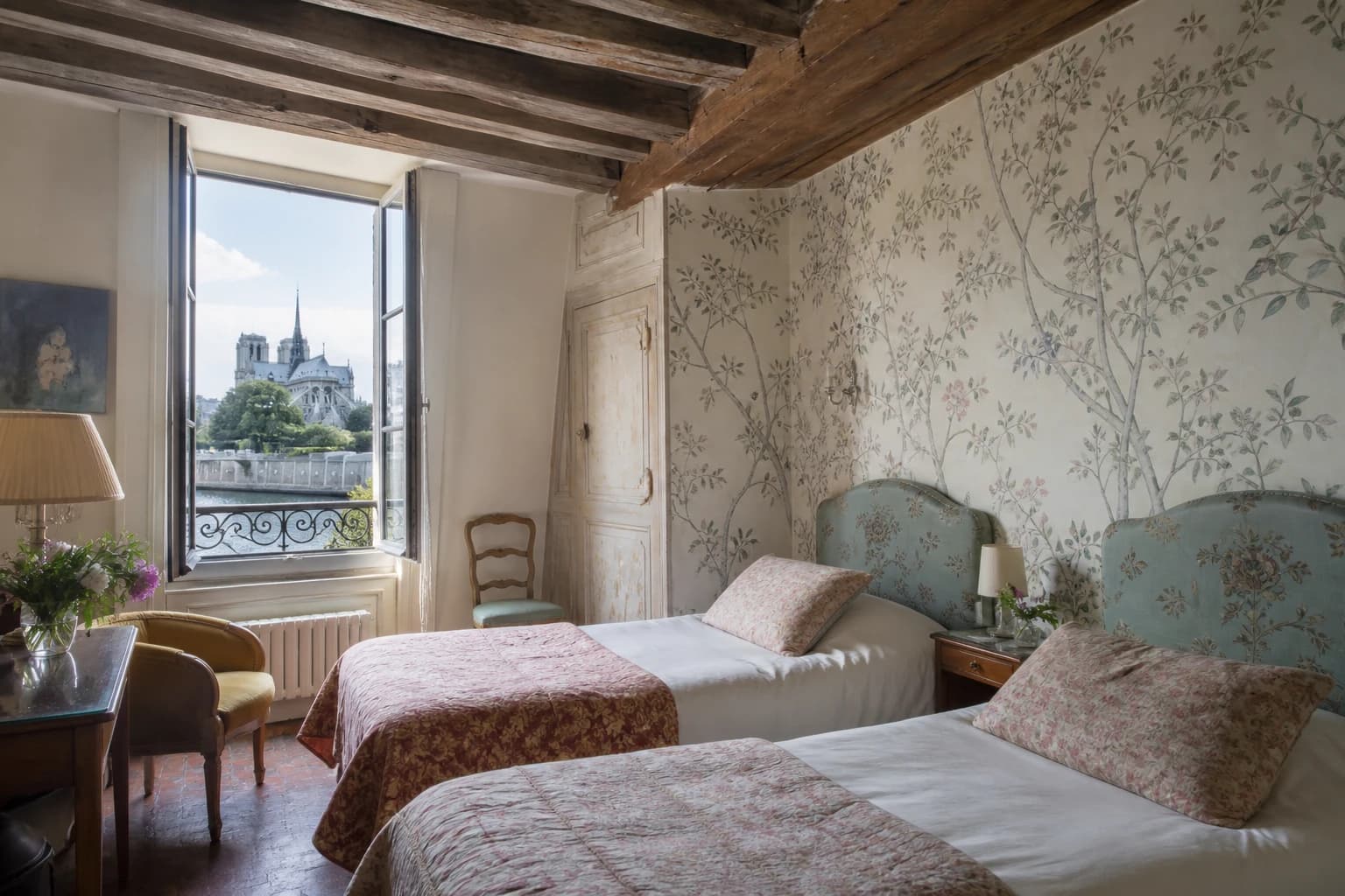 Editorial illustration of a Hôtel Esmeralda twin room beneath old beams with botanical wallpaper, vintage chairs, and a partial Notre-Dame view.