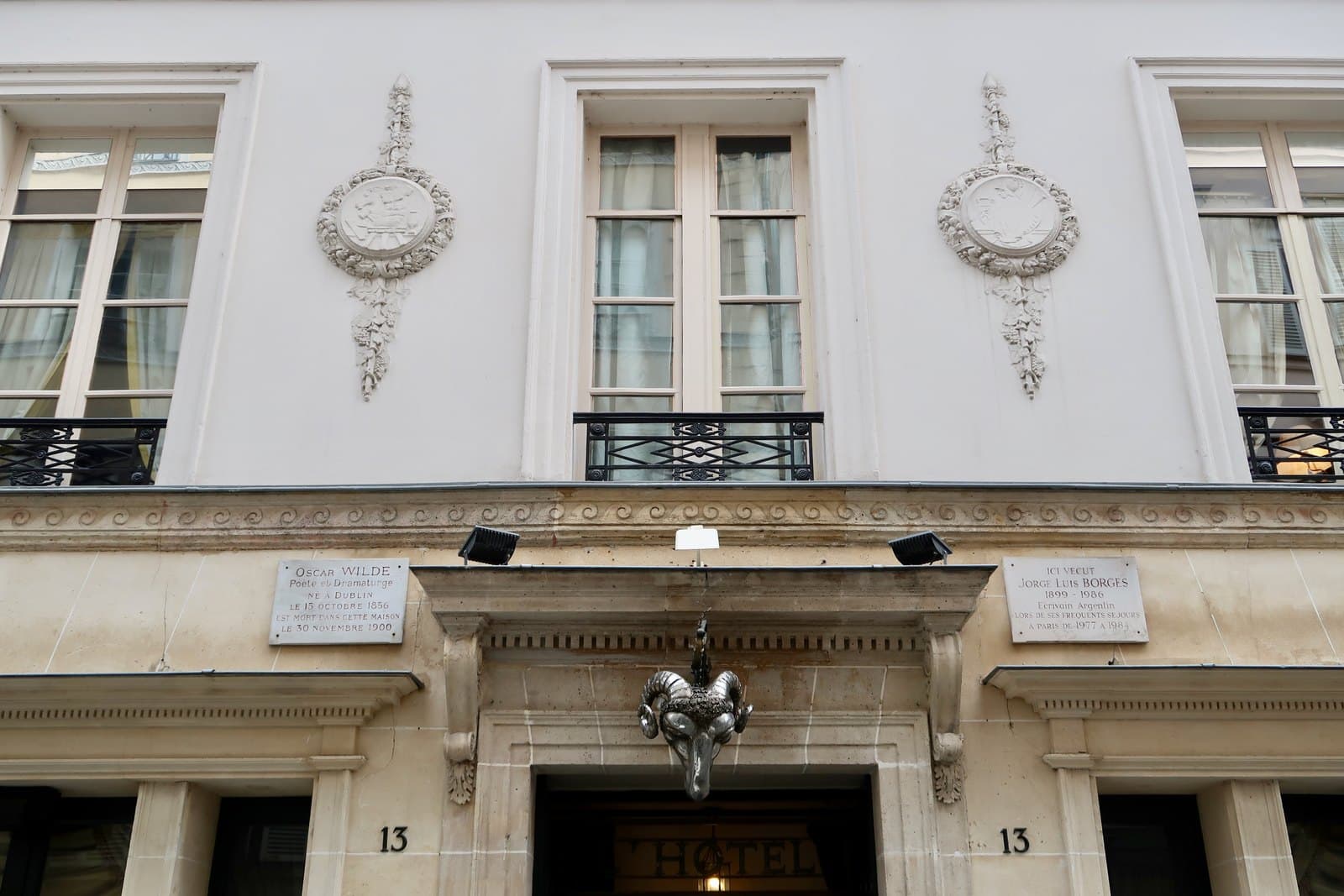 The entrance and cream stone façade of L’Hôtel on rue des Beaux-Arts.