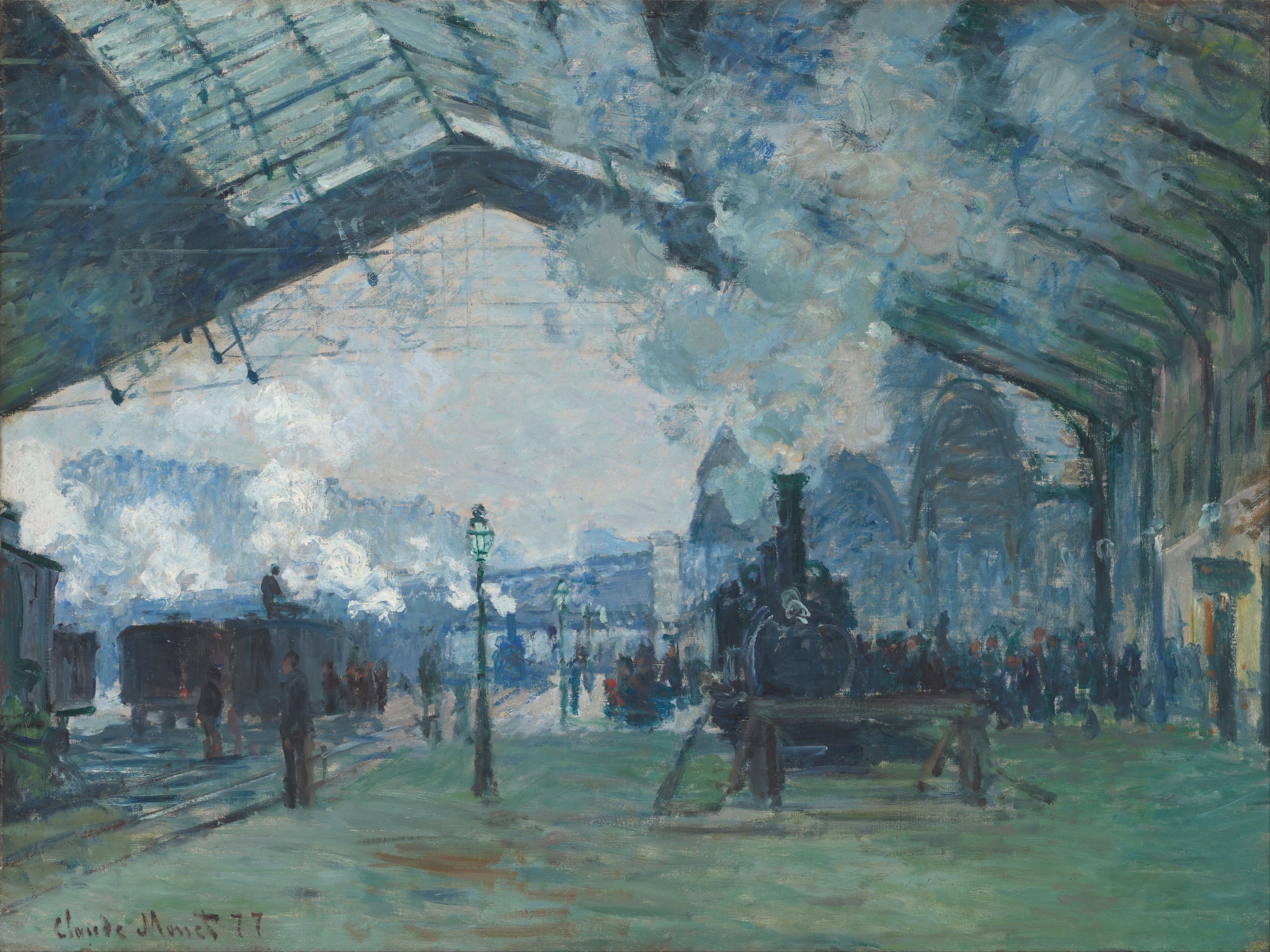 Close view of pale locomotive steam spreading beneath the dark iron ribs and glass roof of the Gare Saint-Lazare